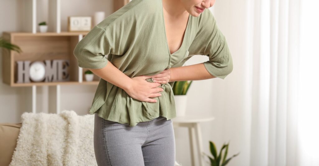 Woman suffering from abdominal pain.