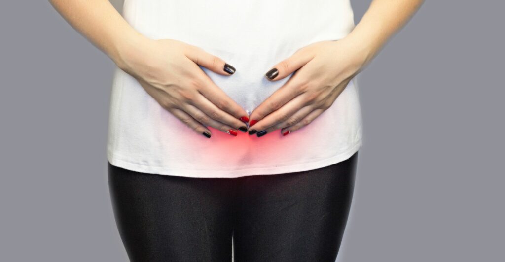 woman holding lower abdomen