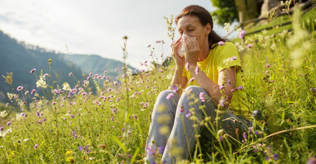 woman sneezing around flowers
